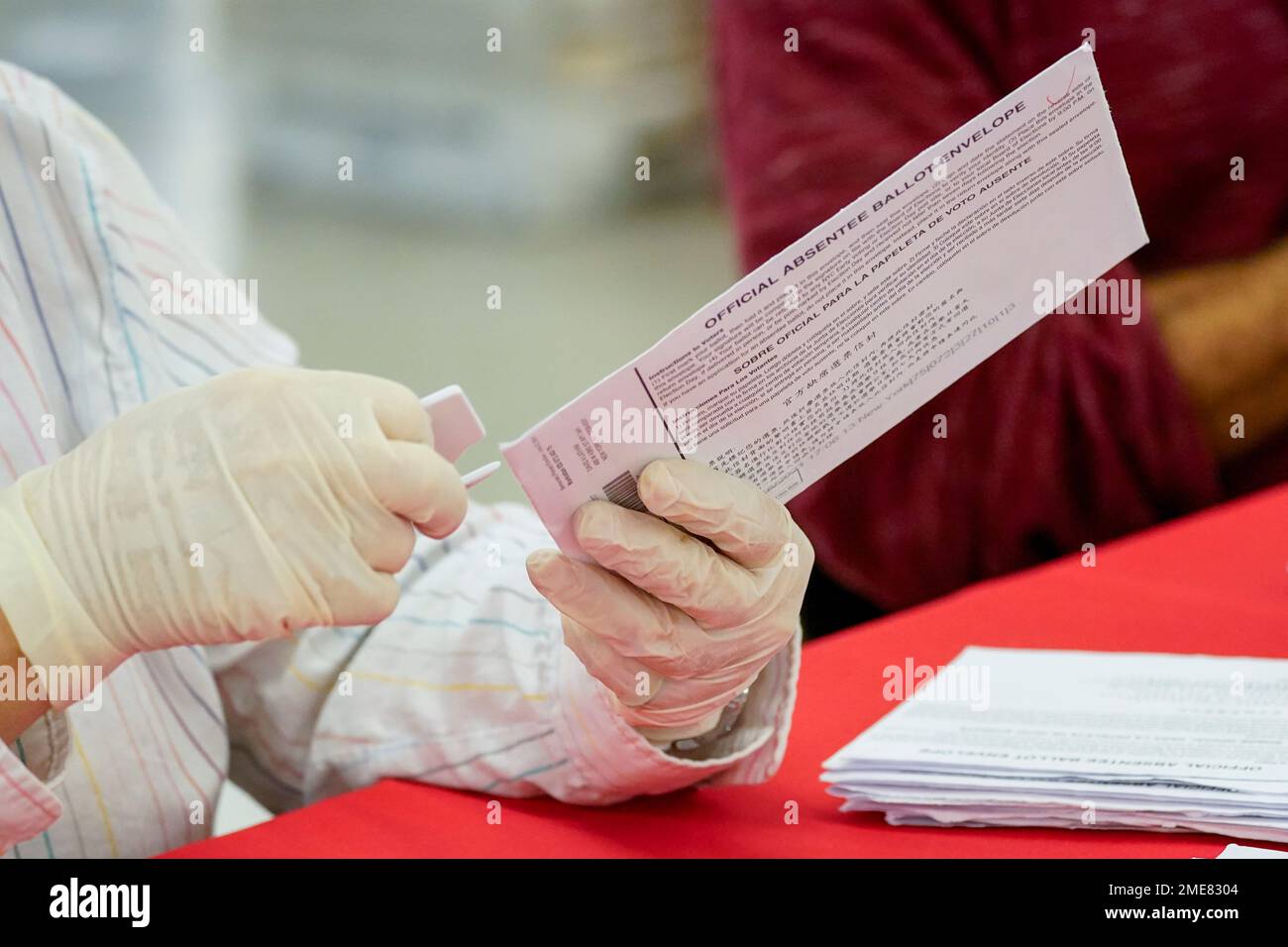 New York City Board of Election staff member removes an absentee ballot