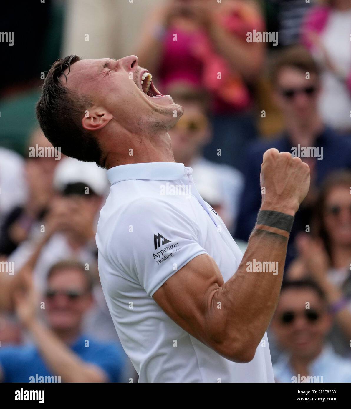 Hungarys Marton Fucsovics celebrates after defeating Russias Andrey Rublev during the mens singles fourth round match on day seven of the Wimbledon Tennis Championships in London, Monday, July 5, 2021