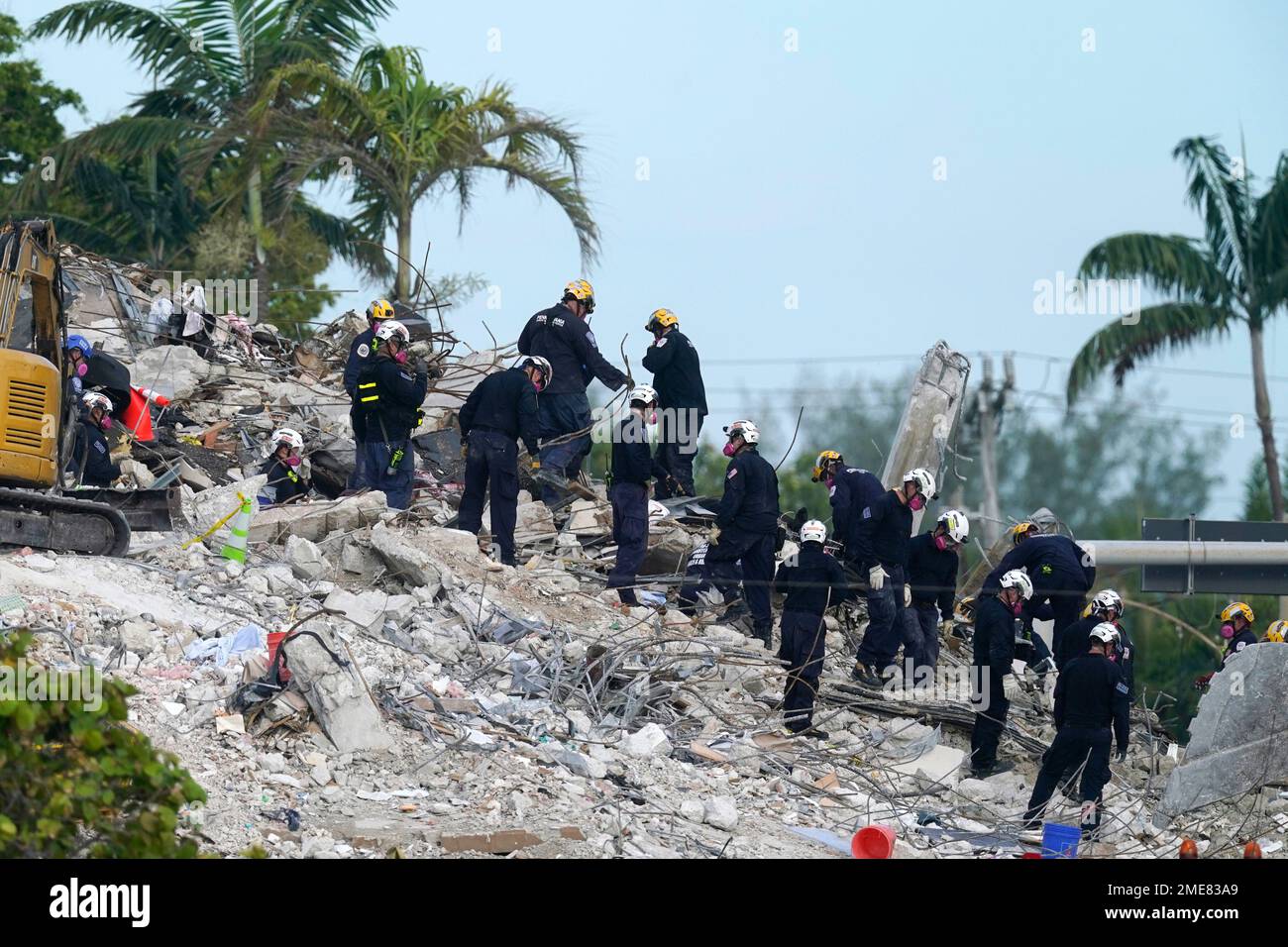 Rescue crews work at the site of the collapsed Champlain Towers South ...