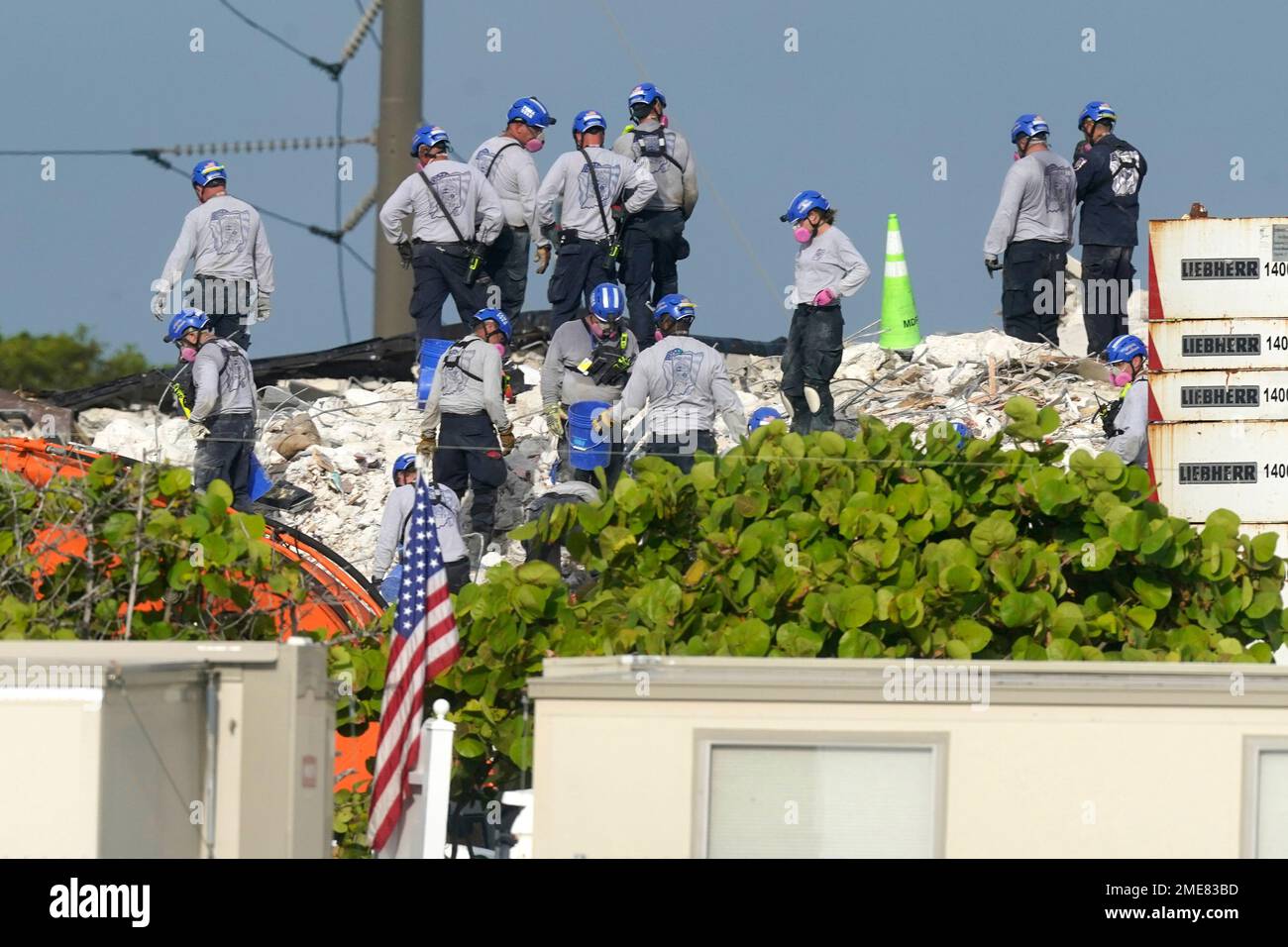 Rescue crews work at the site of the collapsed Champlain Towers South ...