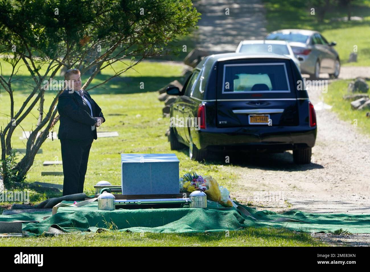 Shannon Walters, of the John Vincent Scalia Home for Funerals, stands by as people leave after