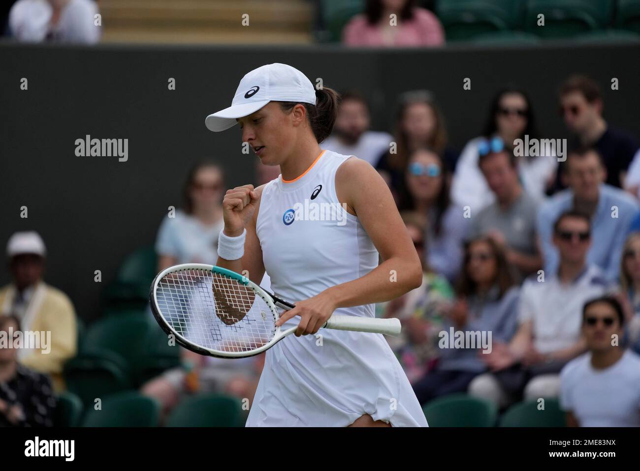 Polands Iga Swiatek celebrates a point against Tunisias Ons Jabeur during the womens singles fourth round match on day seven of the Wimbledon Tennis Championships in London, Monday, July 5, 2021