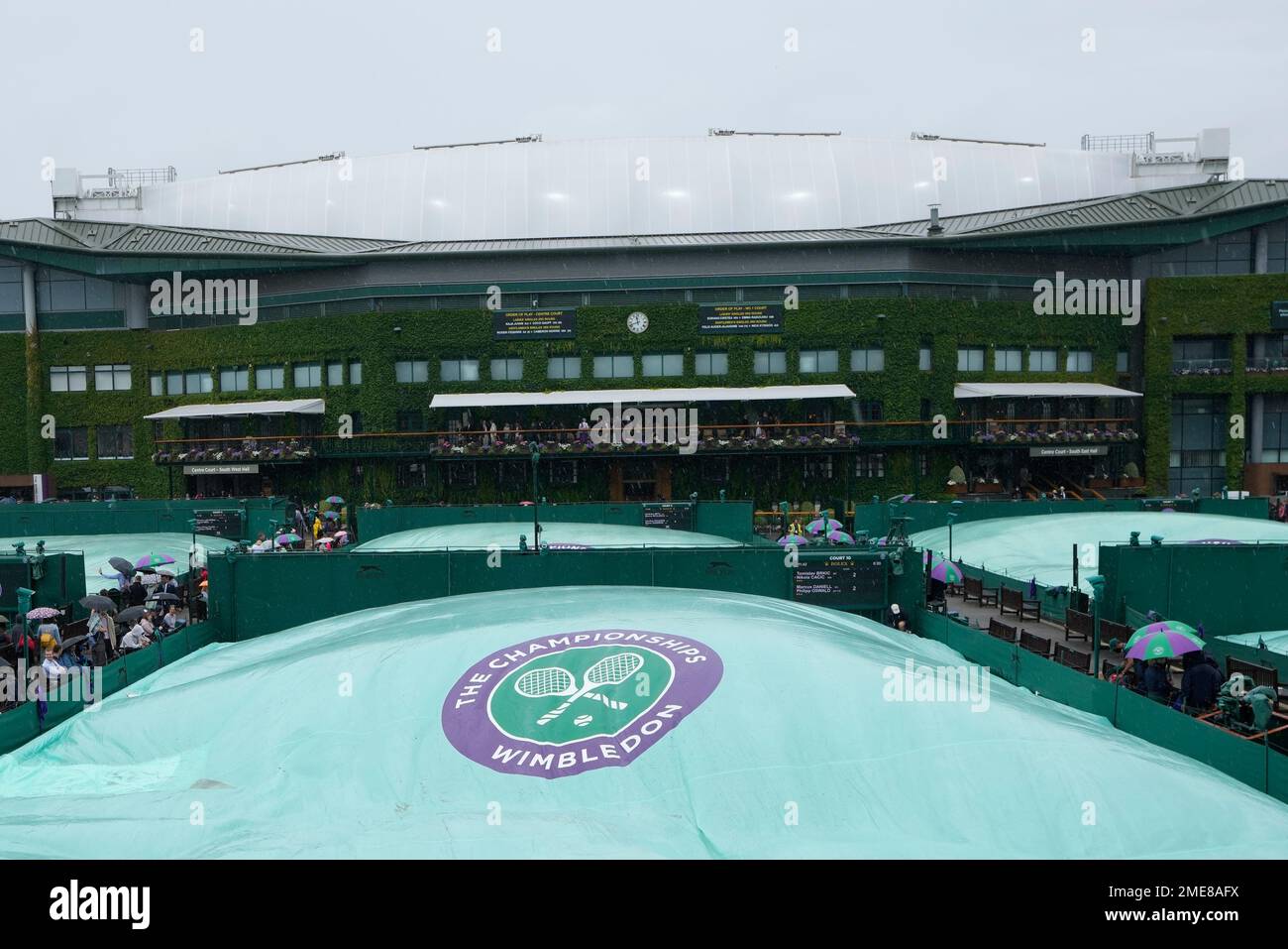 Outside courts are covered during a rain delay on day six of the Wimbledon Tennis Championships