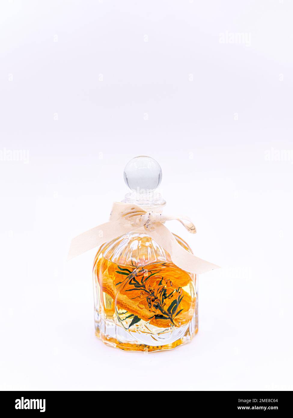 Reed diffuser with cinnamon and orange on white background Stock Photo