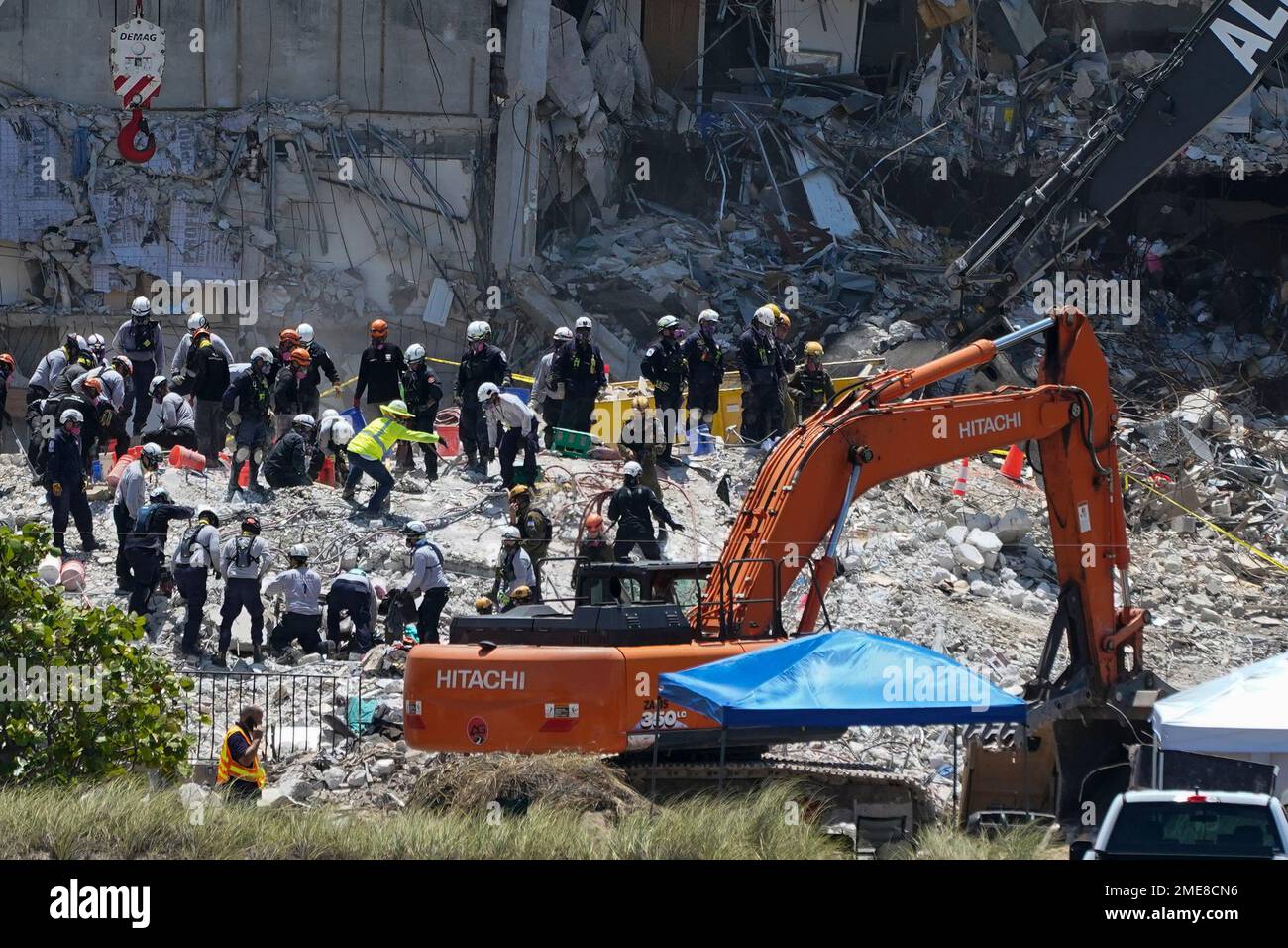 Search and rescue personnel work atop the rubble at the Champlain ...