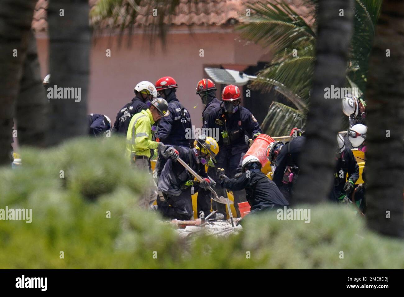 Search and rescue personnel work atop the rubble at the Champlain ...