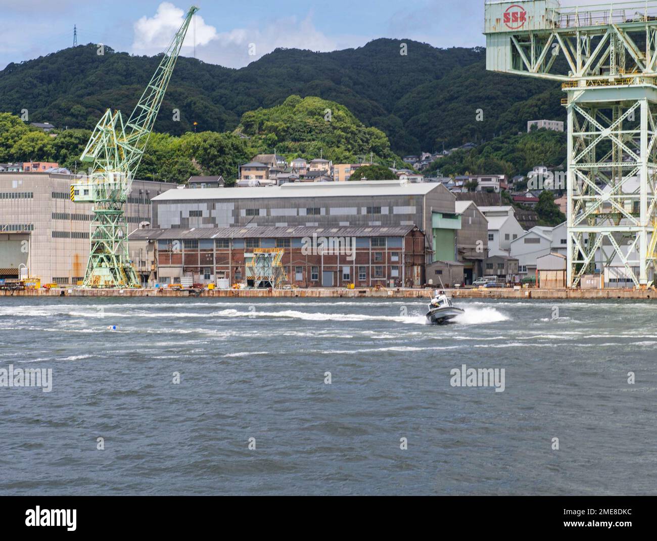 Sailors assigned to Commander, Fleet Activities Sasebo (CFAS) execute high speed boat maneuvers to disperse a simulated crashed unmanned aerial system as part of an anti-terrorism training drill during Exercise Citadel Pacific 2022 (CP22) at CFAS Aug. 15, 2022. CP22 is an annual exercise that is not in response to any specific real world threat but is used to evaluate the readiness of fleet and installation security programs. Stock Photo