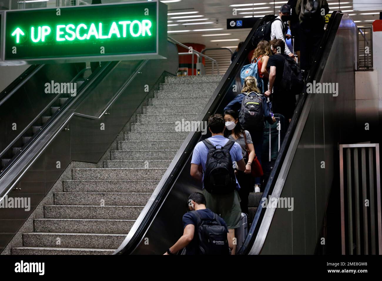 Passengers ride the escalator at O'Hare International Airport "L" train