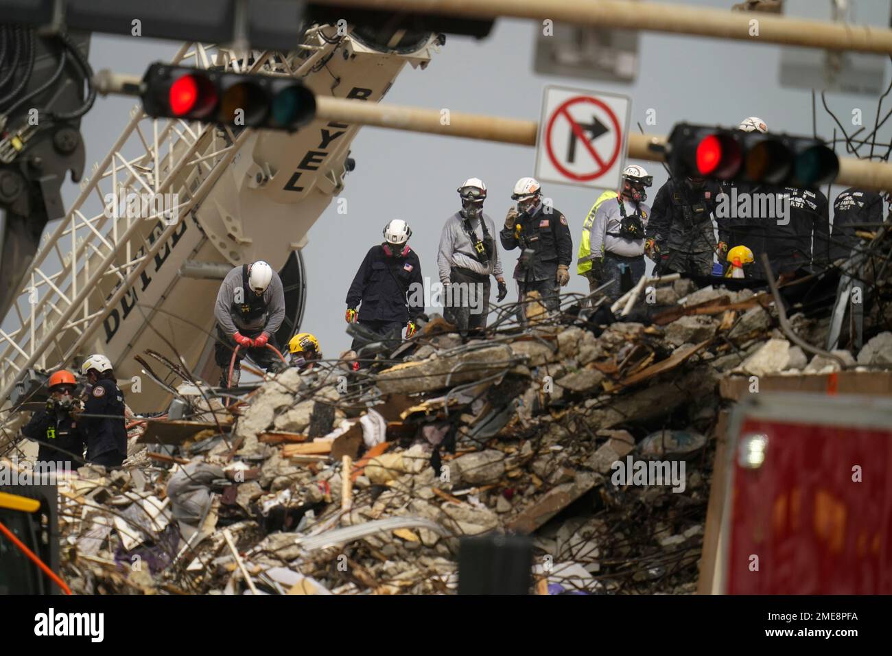 Search and rescue personnel work atop the rubble at the Champlain ...