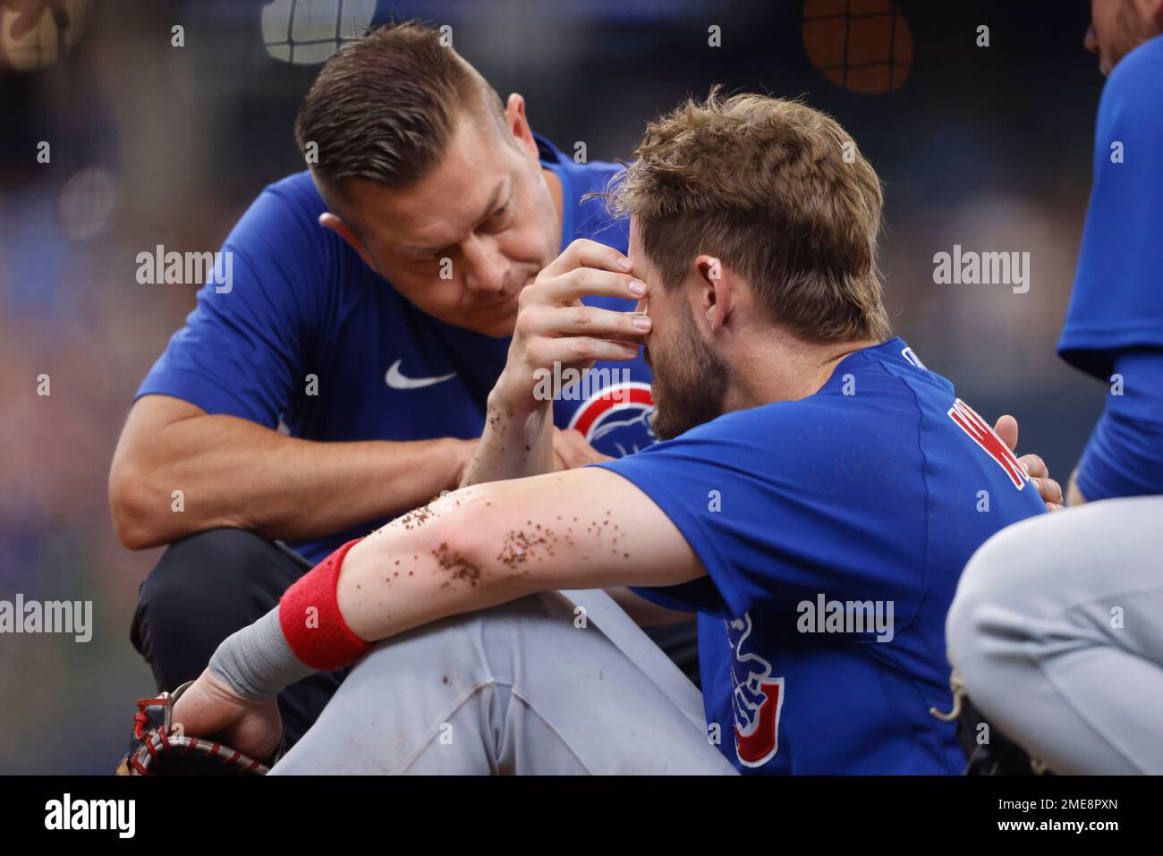 Chicago Cubs third base coach Willie Harris talks to Patrick Wisdom in the  dugout before a baseball game against the San Diego Padres Wednesday, June  15, 2022, in Chicago. (AP Photo/Charles Rex