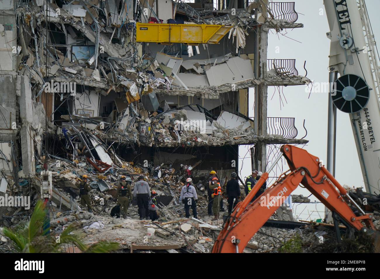 Search and rescue personnel work atop the rubble at the Champlain ...
