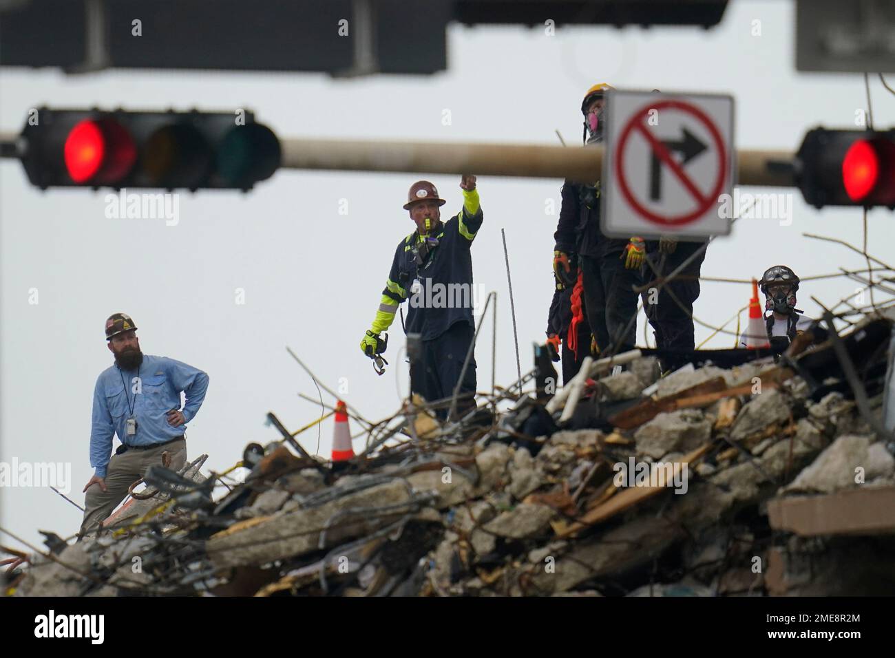Search and rescue personnel work atop the rubble at the Champlain ...