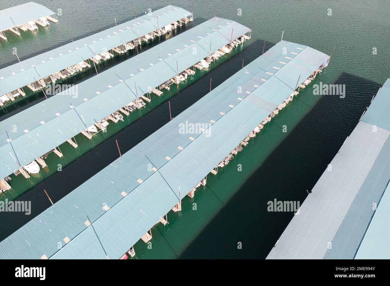 Aerial top down view of boat dock and yacht port, white private motor