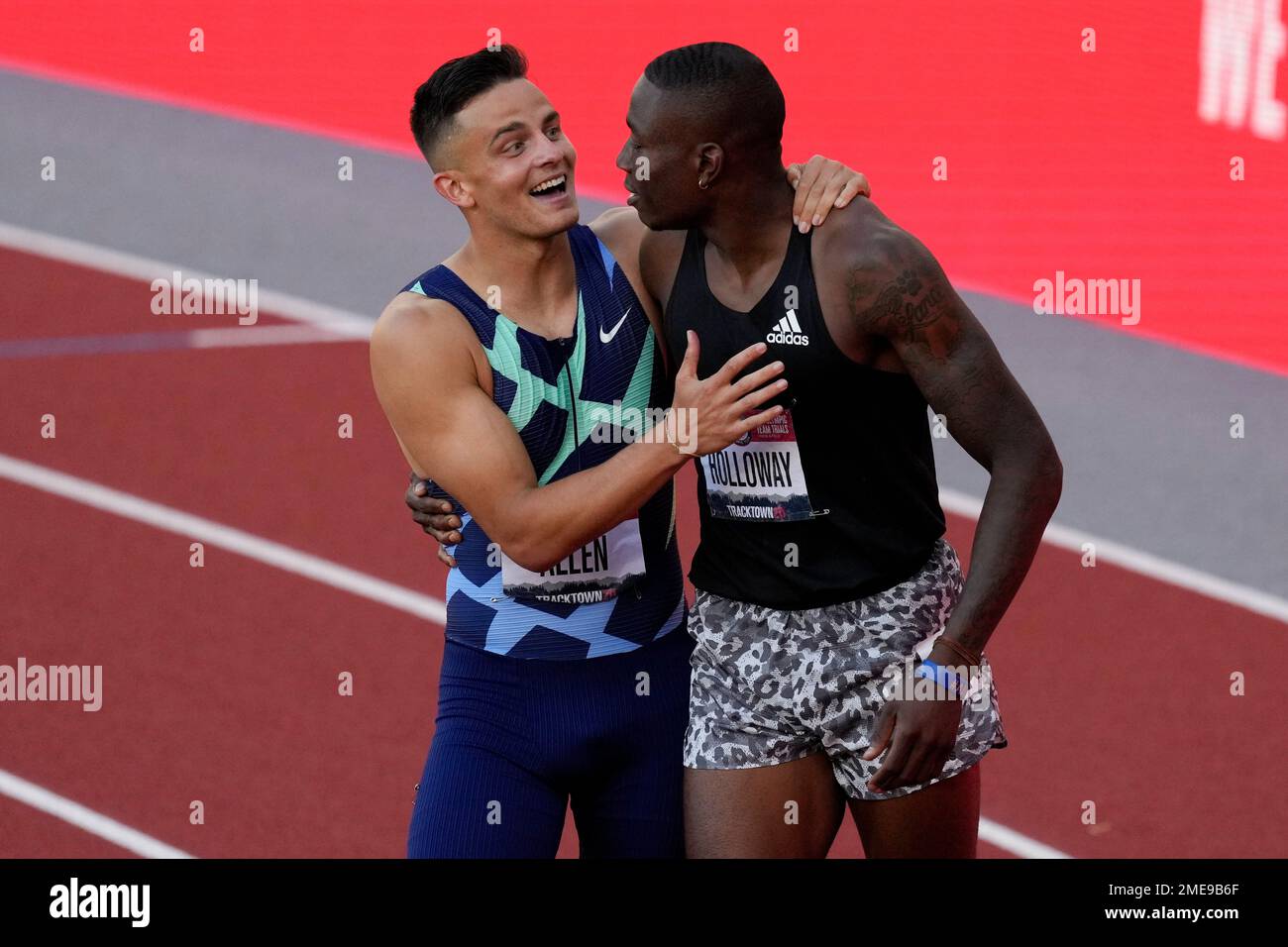 Grant Holloway, right, celebrates after winning the final in the