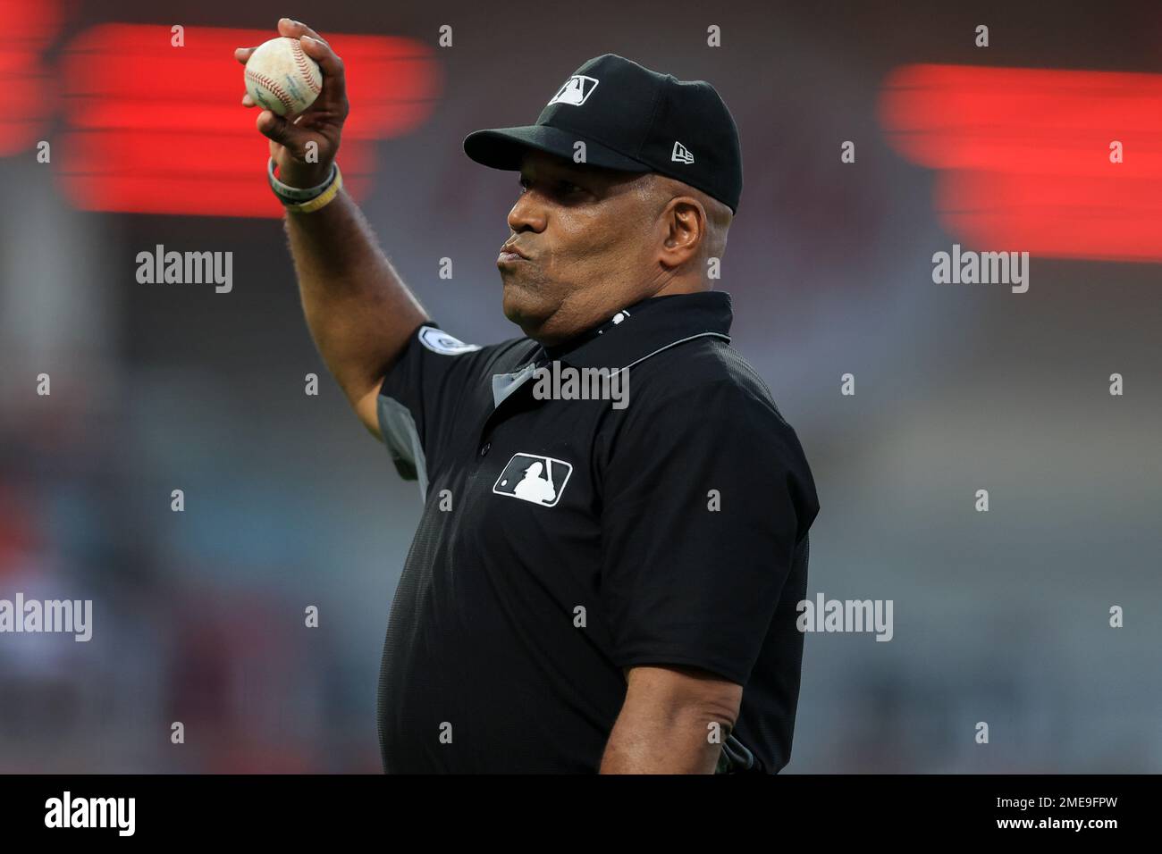 MLB umpire Laz Diaz looks to throw a baseball into the stands