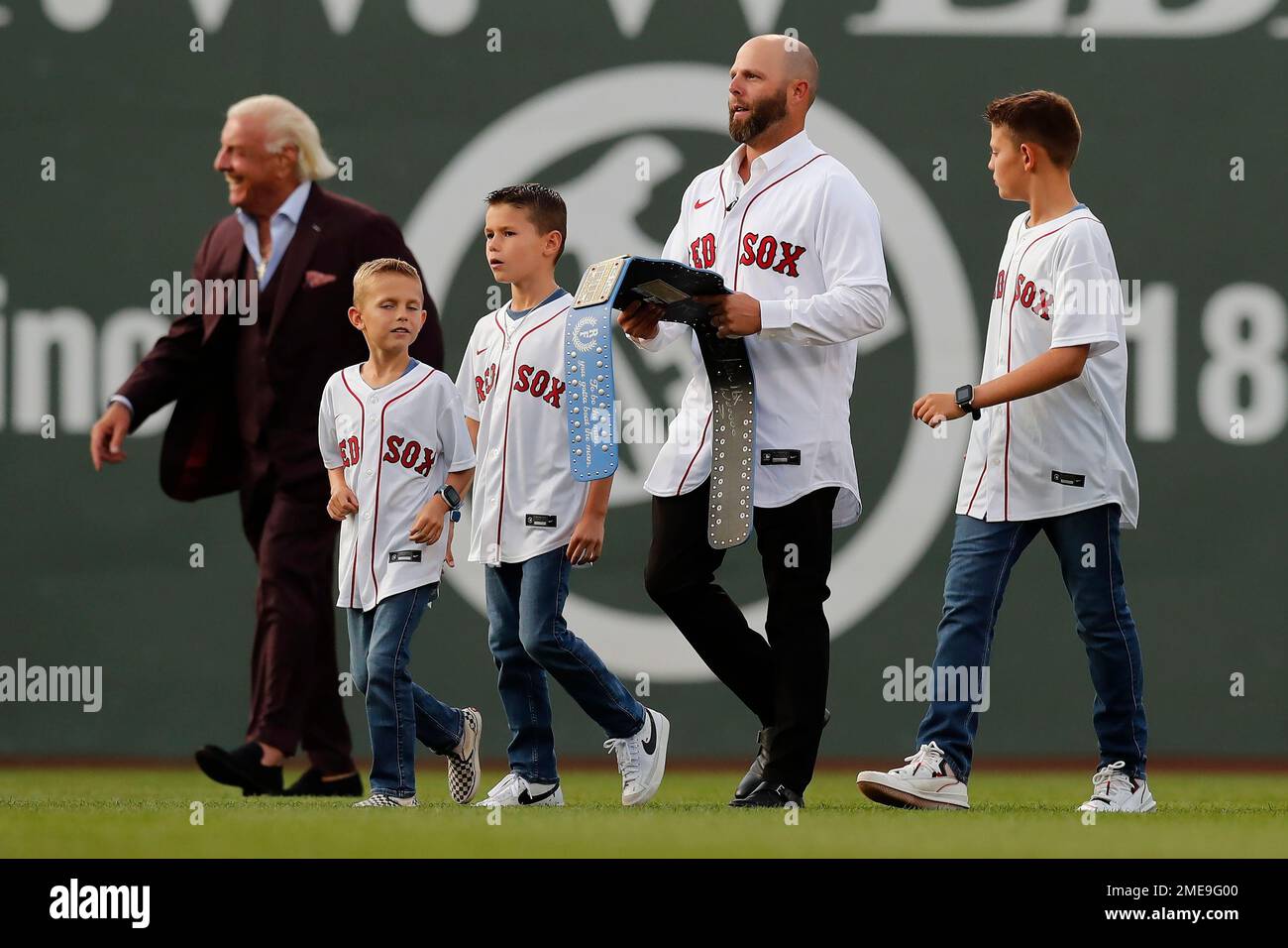 Former Boston Red Sox's Dustin Pedroia, center, addresses fans during  ceremonies in his honor before a baseball game against the New York  Yankees, Friday, June 25, 2021, in Boston. (AP Photo/Michael Dwyer