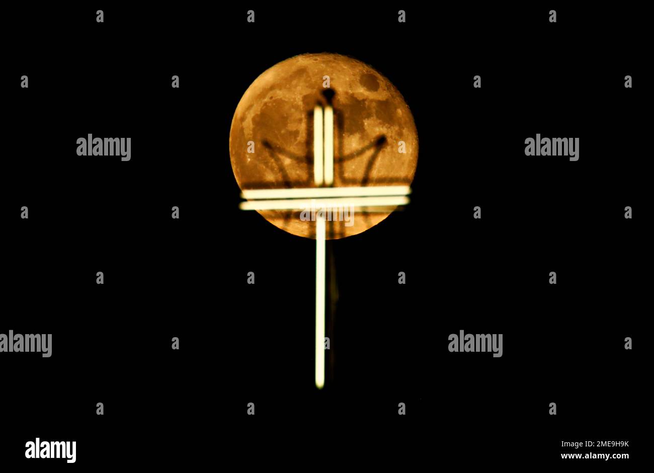 The moon rises over the cross of St. Joseph Church in Baghdad, Iraq