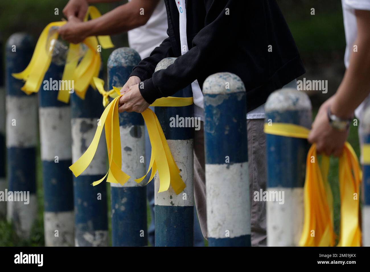 Supporters tie yellow ribbons as they offer prayers for former ...