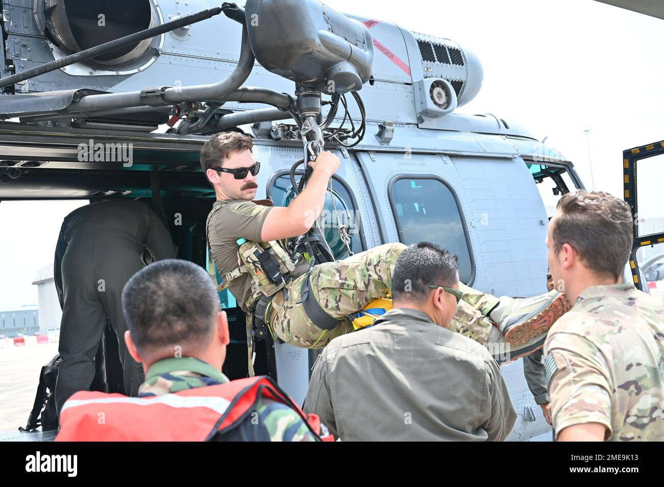 A U.S. Pararescueman Tests The Hoist Equipment Prior To A Search And ...