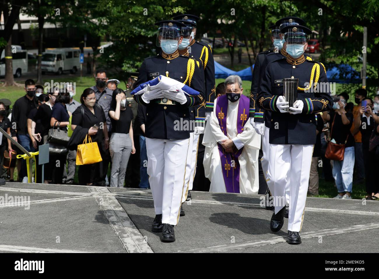 An honor guard carries the urn of former Philippine President Benigno ...