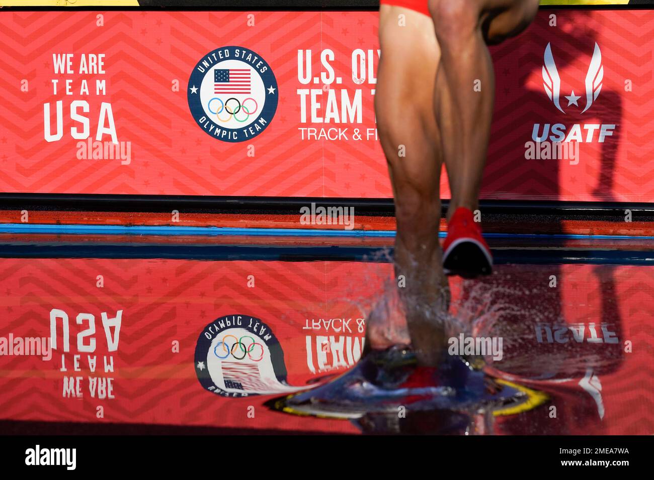A runner enters the water in the first prelim of the women's 3000meter