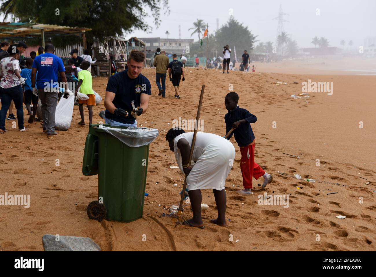 U.S. Coast Guard Ensign Seth Anderson assigned to USCGC Mohawk (WMEC 913) participates in a beach clean-up with 350 Côte d’Ivoire and local kids at Vridi Beach in Abidjan, Côte d’Ivoire, Aug. 15, 2022. Mohawk is on a scheduled deployment in the U.S. Naval Forces Africa area of operations, employed by U.S. Sixth Fleet to defend U.S., allied, and partner interests. Stock Photo
