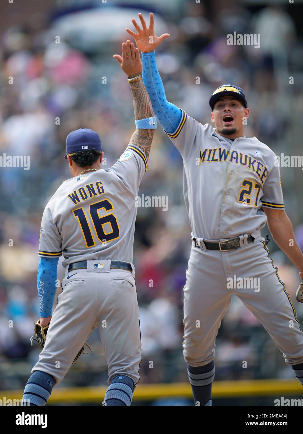 Milwaukee Brewers shortstop Willy Adames, right, celebrates with second  baseman Kolten Wong after a baseball game