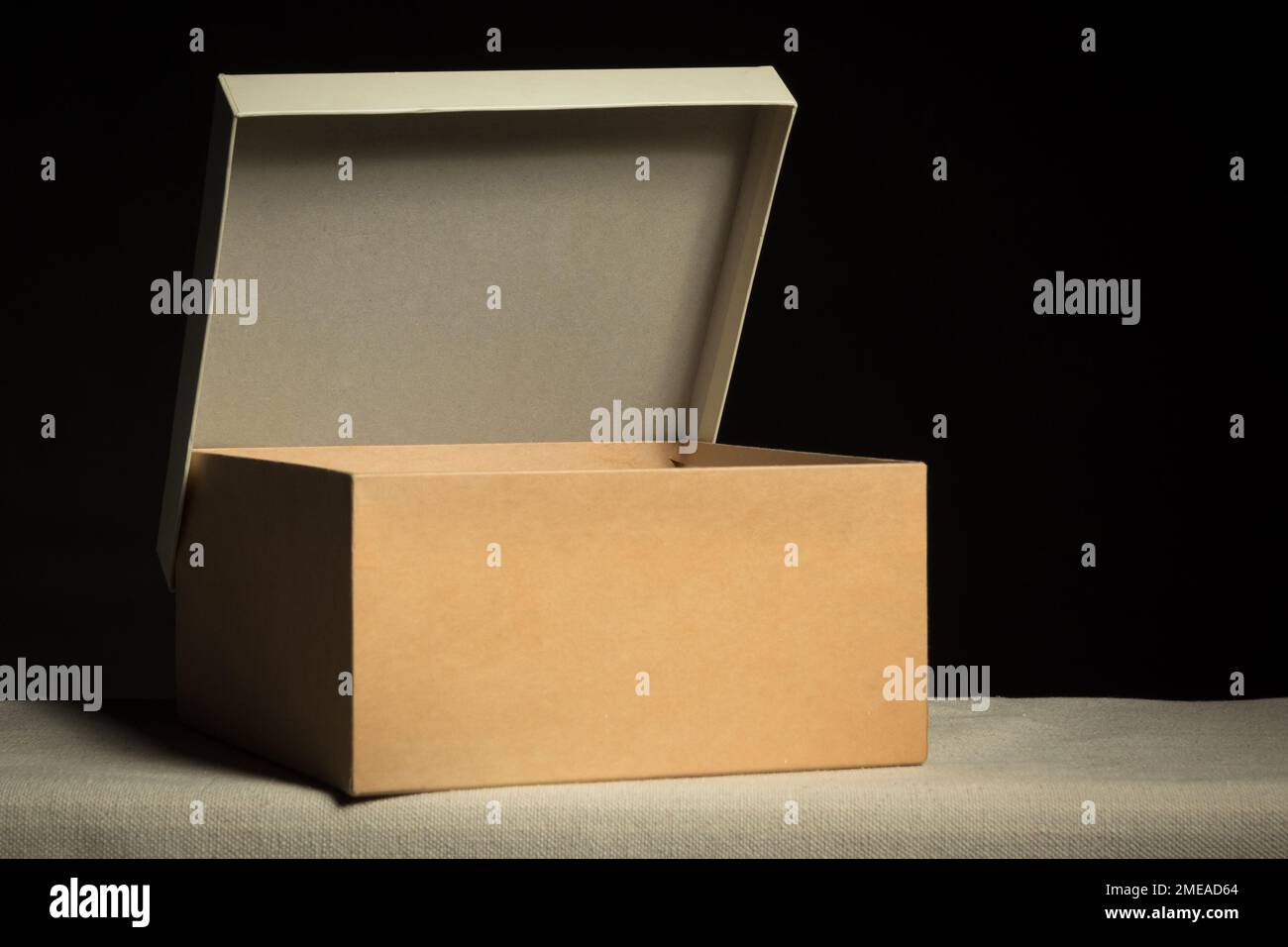 Open cardboard box on black background, copy space Stock Photo