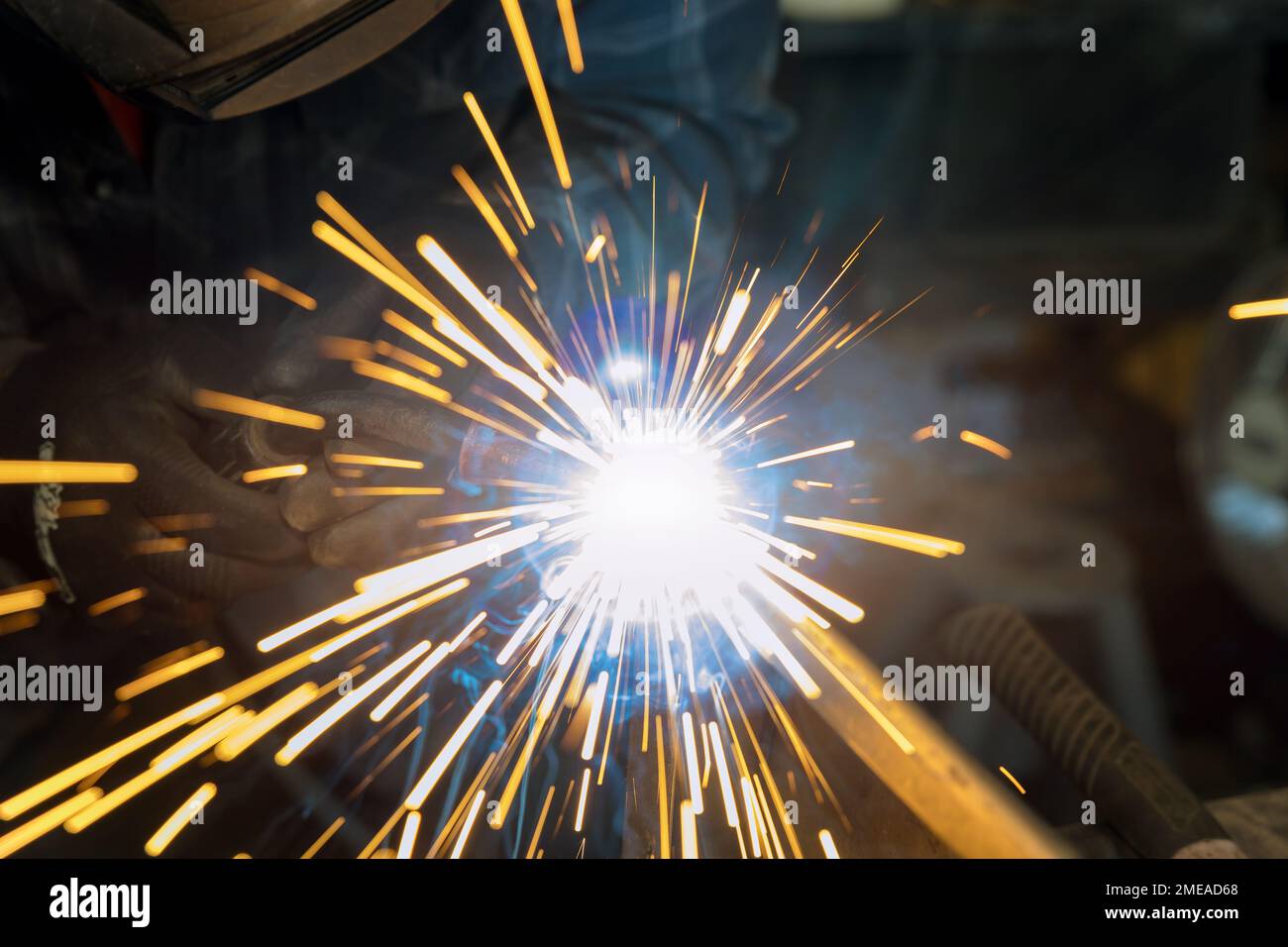 Using semiautomatic argon gas shielded welding semi-automatic machine worker works welding metal Stock Photo