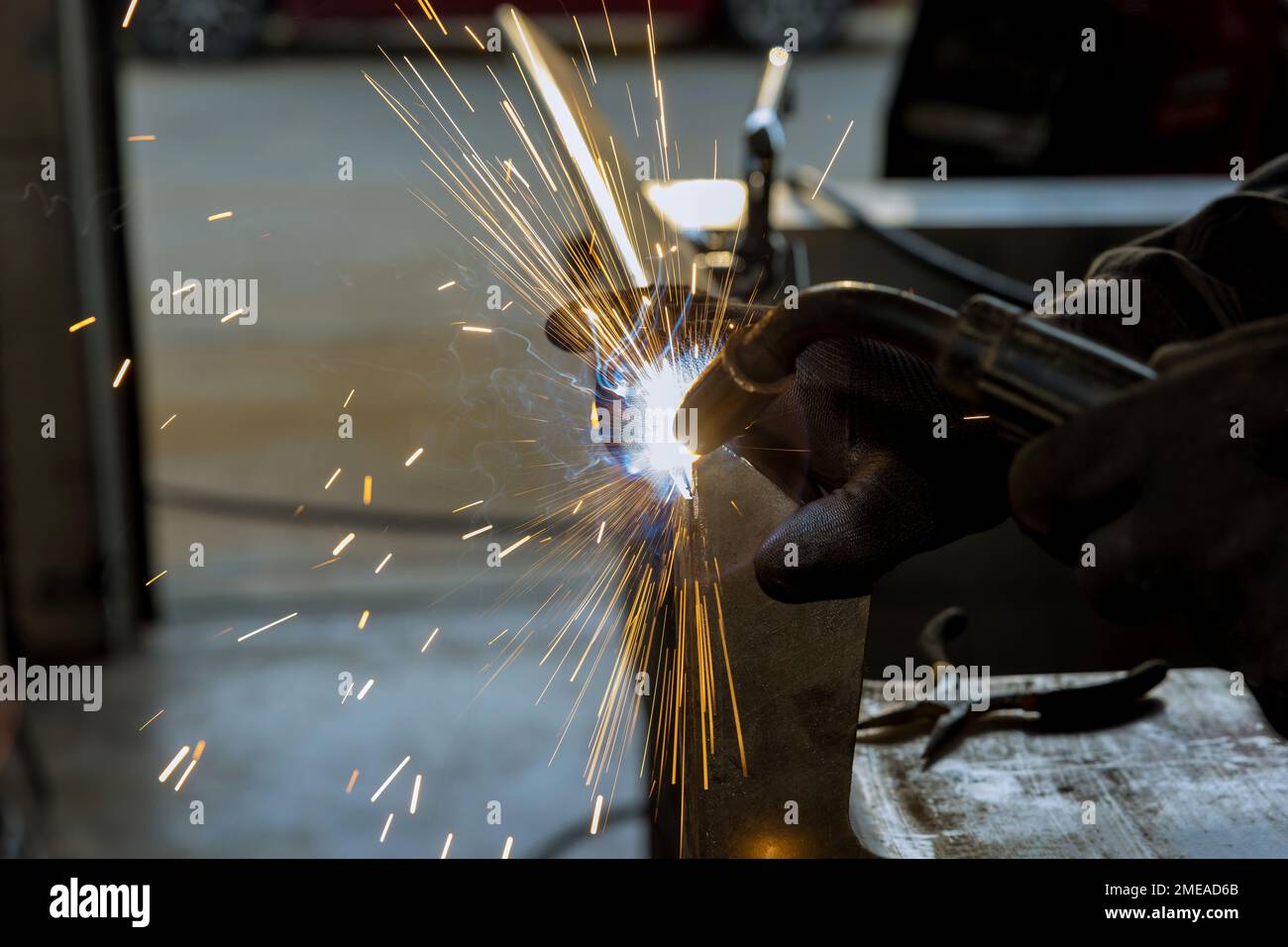Using semi-automatic argon gas shielded welding machine worker is welding metal Stock Photo