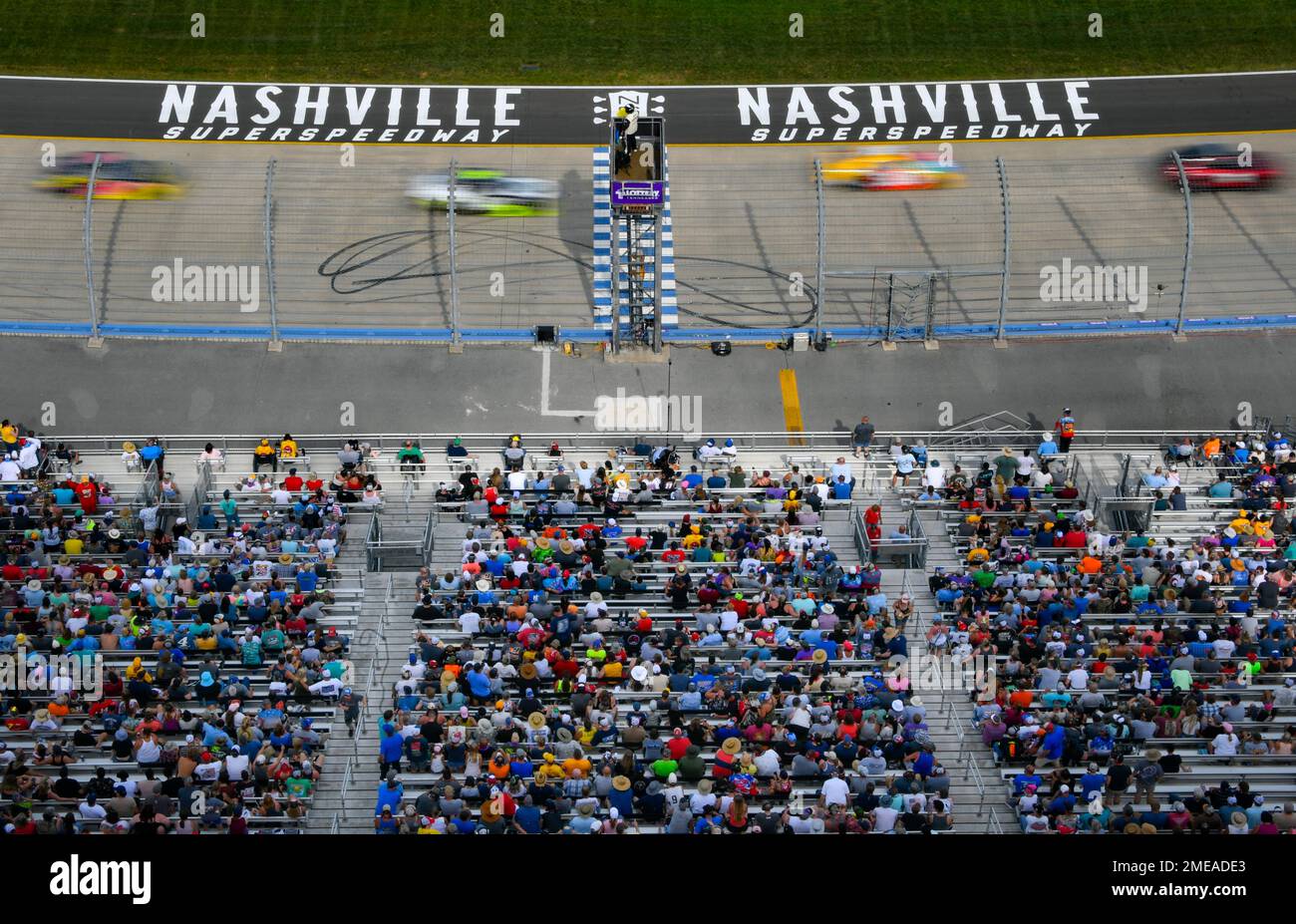 Fans watch a NASCAR Xfinity Series auto race underway Saturday, June 19, 2021, at Nashville Superspeedway in Lebanon, Tenn