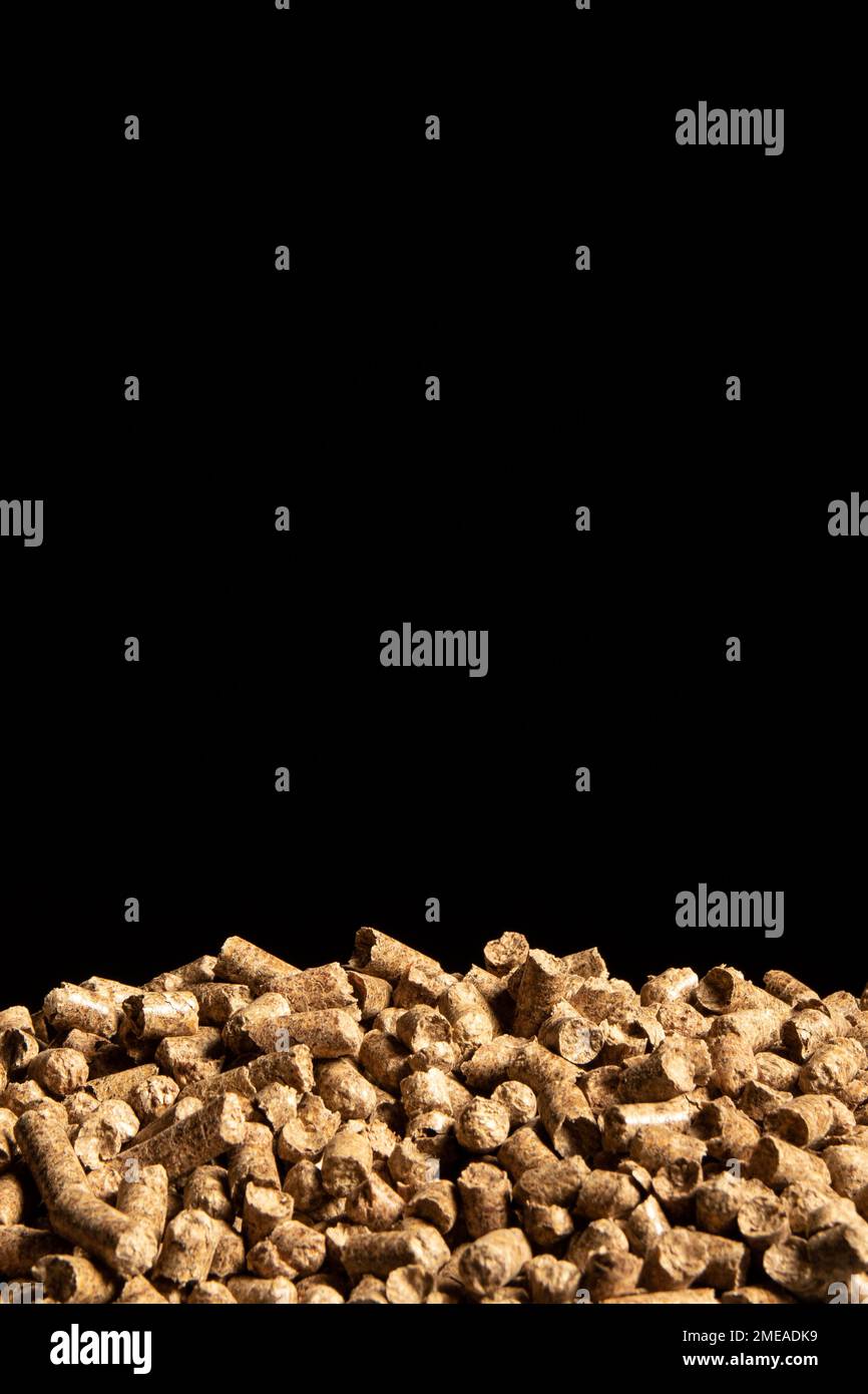 Heap of cat litter pellets on black background Stock Photo