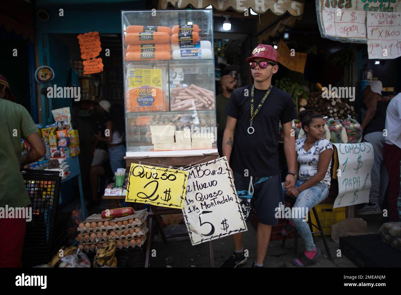 Signs promoting cheese, eggs and mortadella are displayed in a market