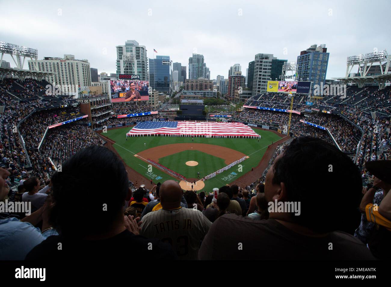 A giant American flag is displayed during the national anthem prior to a baseball game between the San Diego Padres and the Cincinnati Reds Thursday, June 17, 2021, in San Diego. Petco Park opened up for full capacity viewing of a baseball game without masks for the first time since the 2019 season. (AP Photo/Derrick Tuskan) Stock Photo