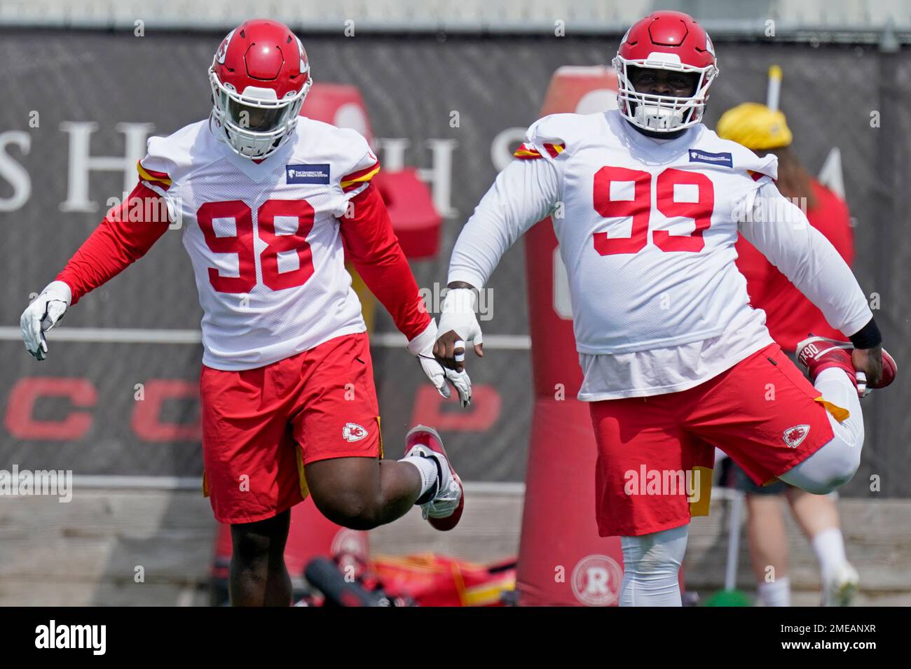 Kansas City Chiefs defensive end Tershawn Wharton (98) and defensive tackle  Khalen Saunders (99) stretch during the NFL football team's minicamp  Wednesday, June 16, 2021, in Kansas City, Mo. (AP Photo/Charlie Riedel