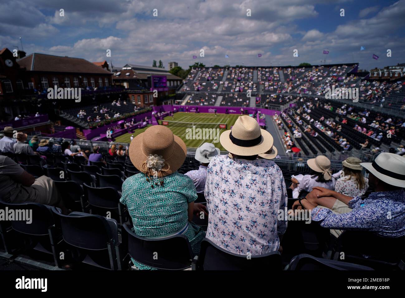Spectators wear hats as they attend the Queen's Club tennis tournament