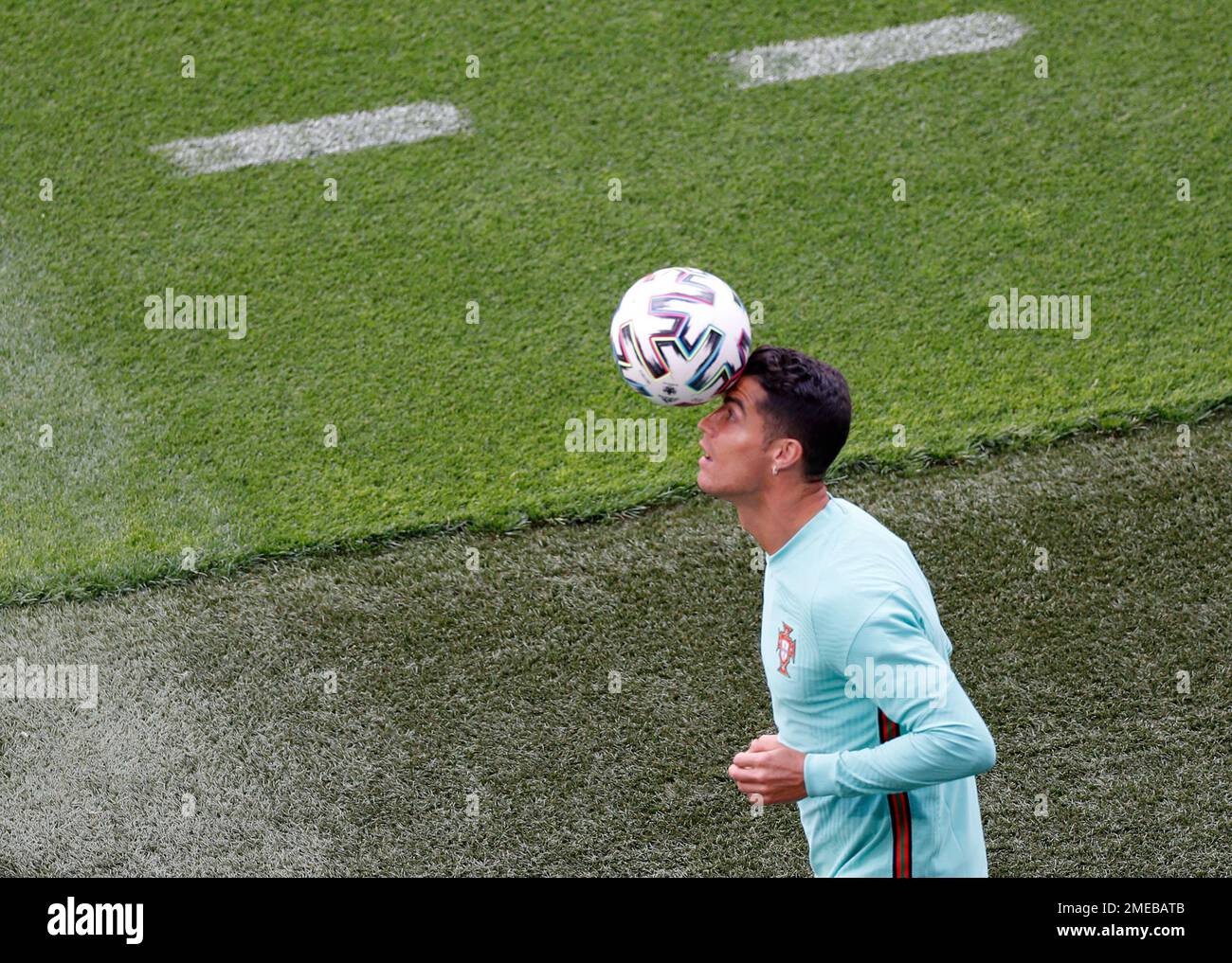 Portugal's Cristiano Ronaldo heads the ball during a team training