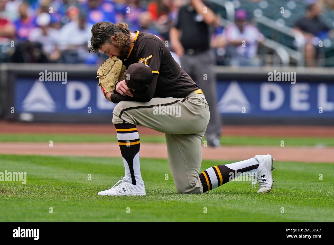 San Diego Padres starting pitcher Chris Paddack kneels before throwing