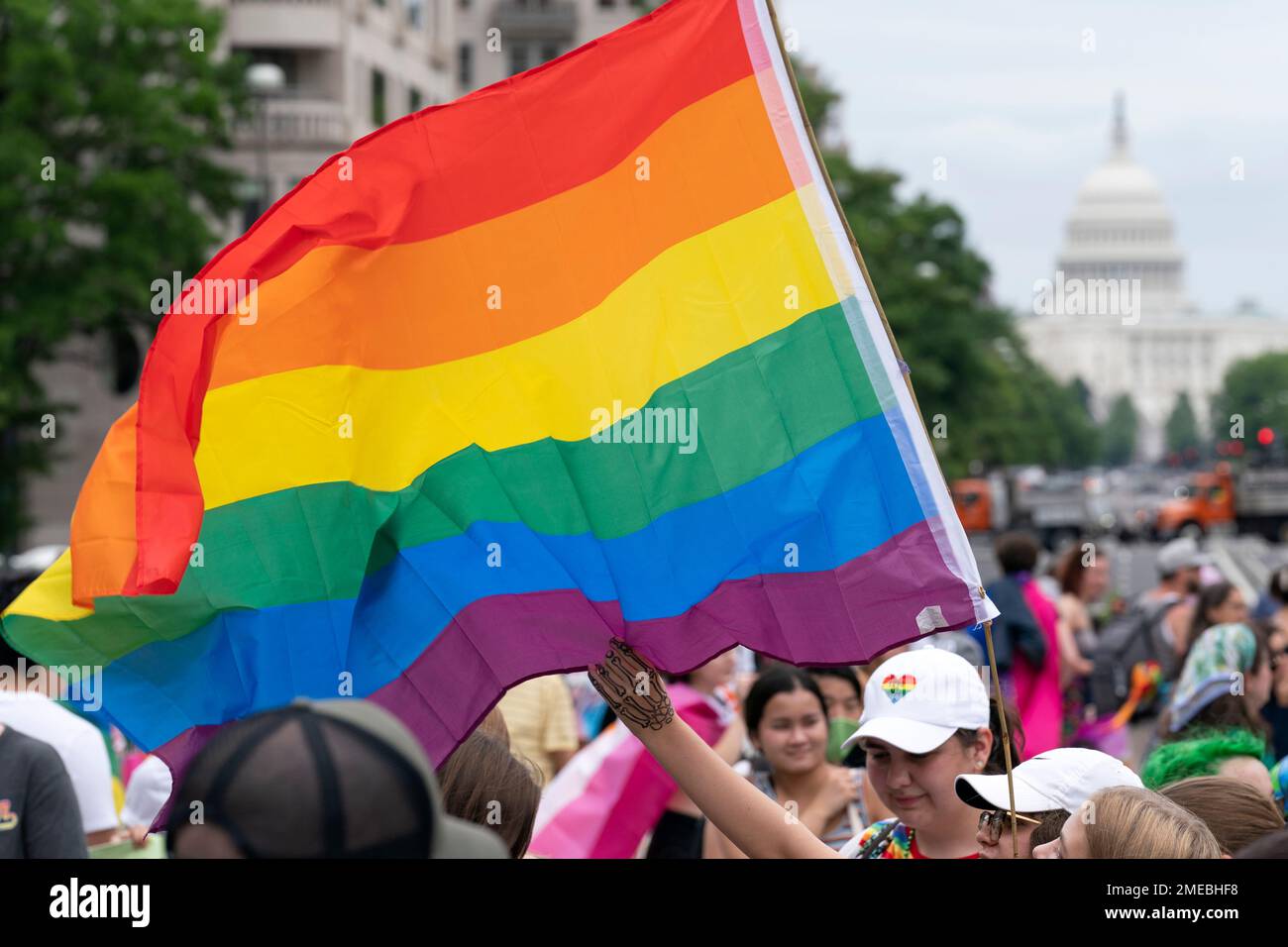 With the U.S. Capitol in the background, LGBTQ participants rally at ...
