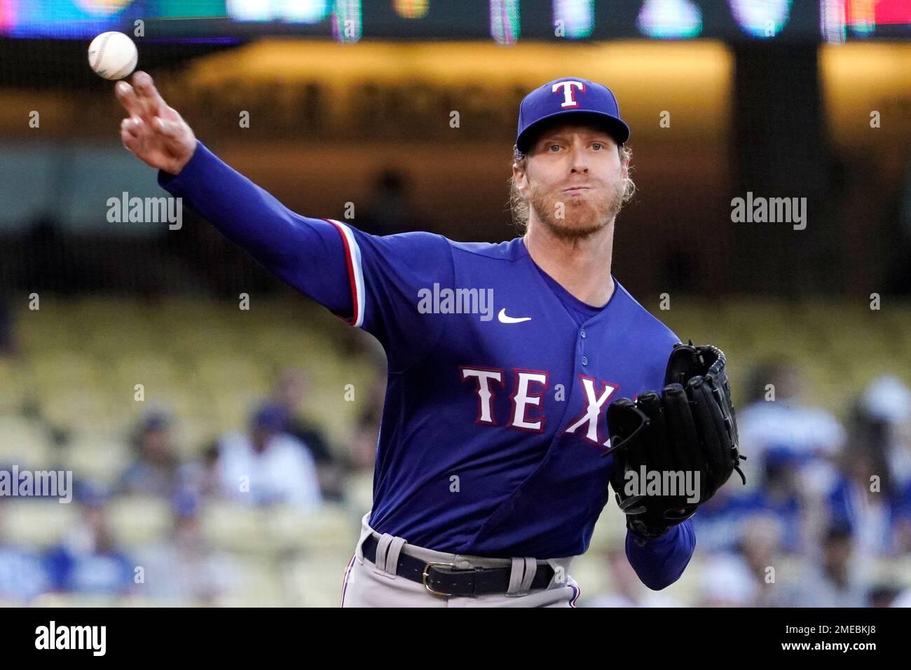 Texas Rangers starting pitcher Mike Foltynewicz throws to first as he tries  to get Los Angeles Dodgers' Mookie Betts off base during the first inning  of a baseball game Friday, June 11,