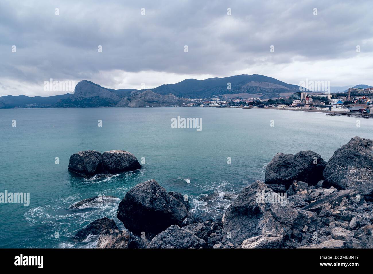 View on coast of the Black Sea of Sudak from Cape Alchak in cloudy weather in spring. Crimea Stock Photo