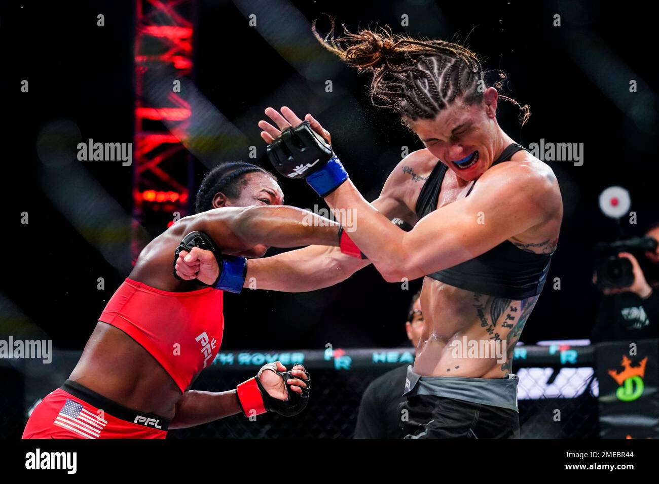 Claressa Shields, left, punches Brittney Elkin during a Professional