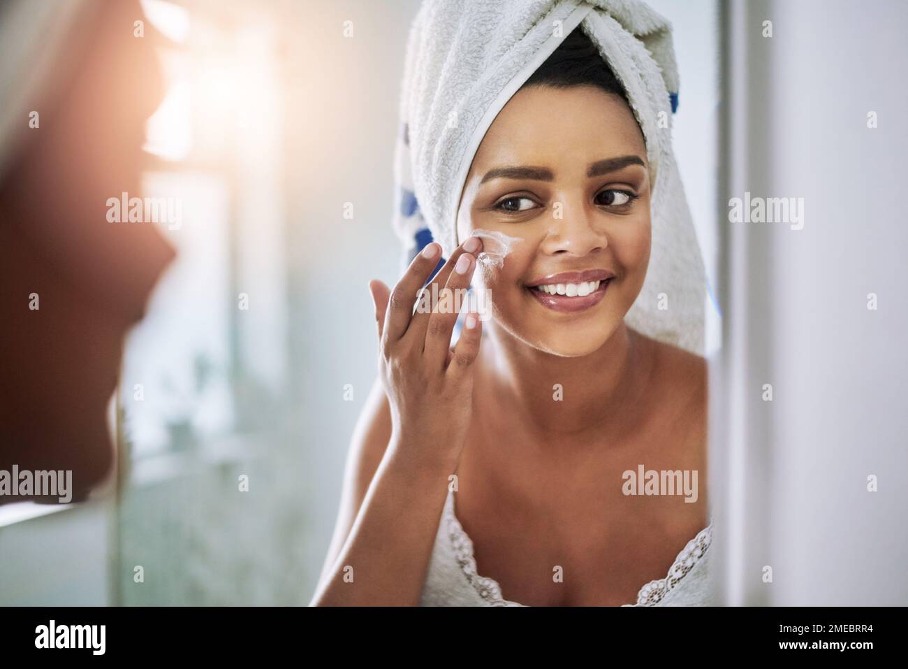 Stepping towards radiant skin. an attractive young woman applying