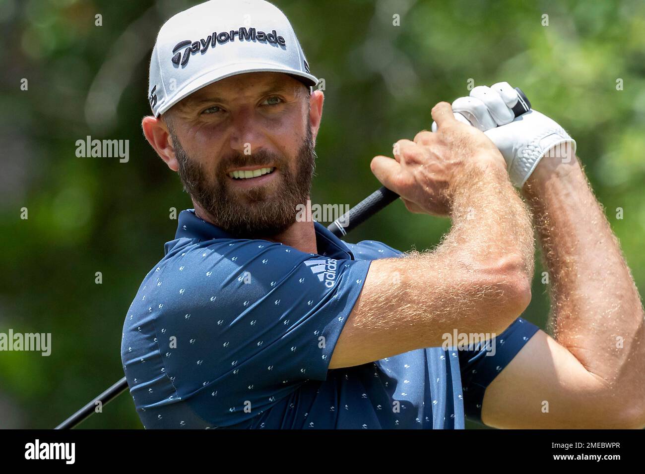 CORRECTS FARAWAY TO FAIRWAY Dustin Johnson watches his drive down the ninth  fairway during the first round of the Palmetto Championship golf tournament  in Ridgeland, S.C., Thursday, June 10, 2021. (AP Photo/Stephen