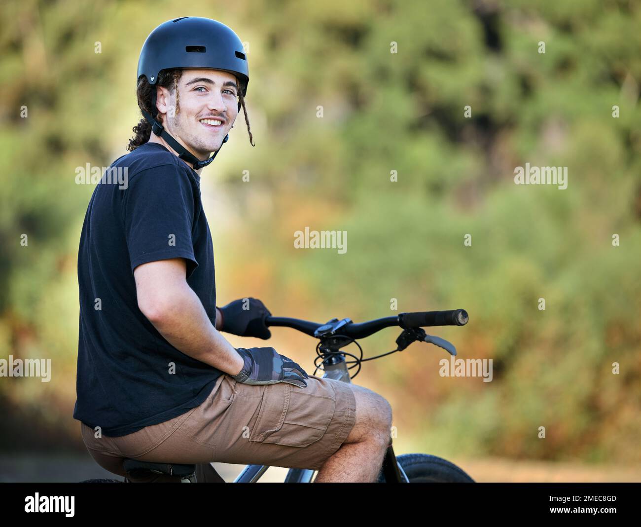 Portrait, bicycle and fitness with a sports man taking a break outdoor