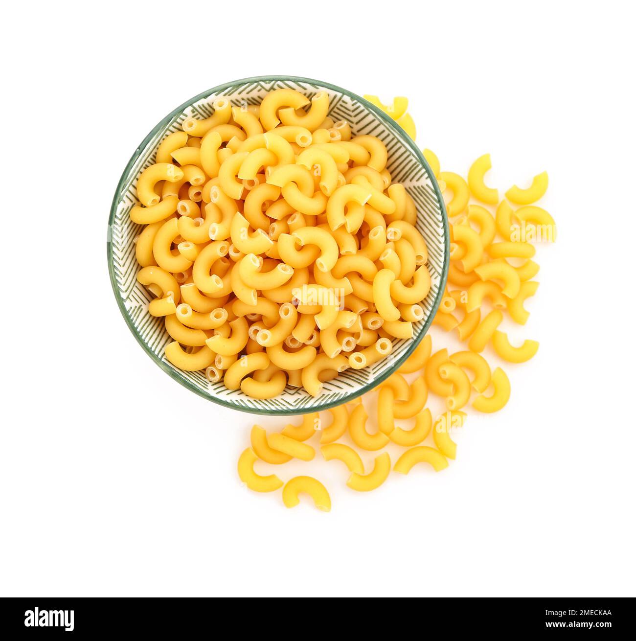 Bowl of raw elbow pasta on white background Stock Photo