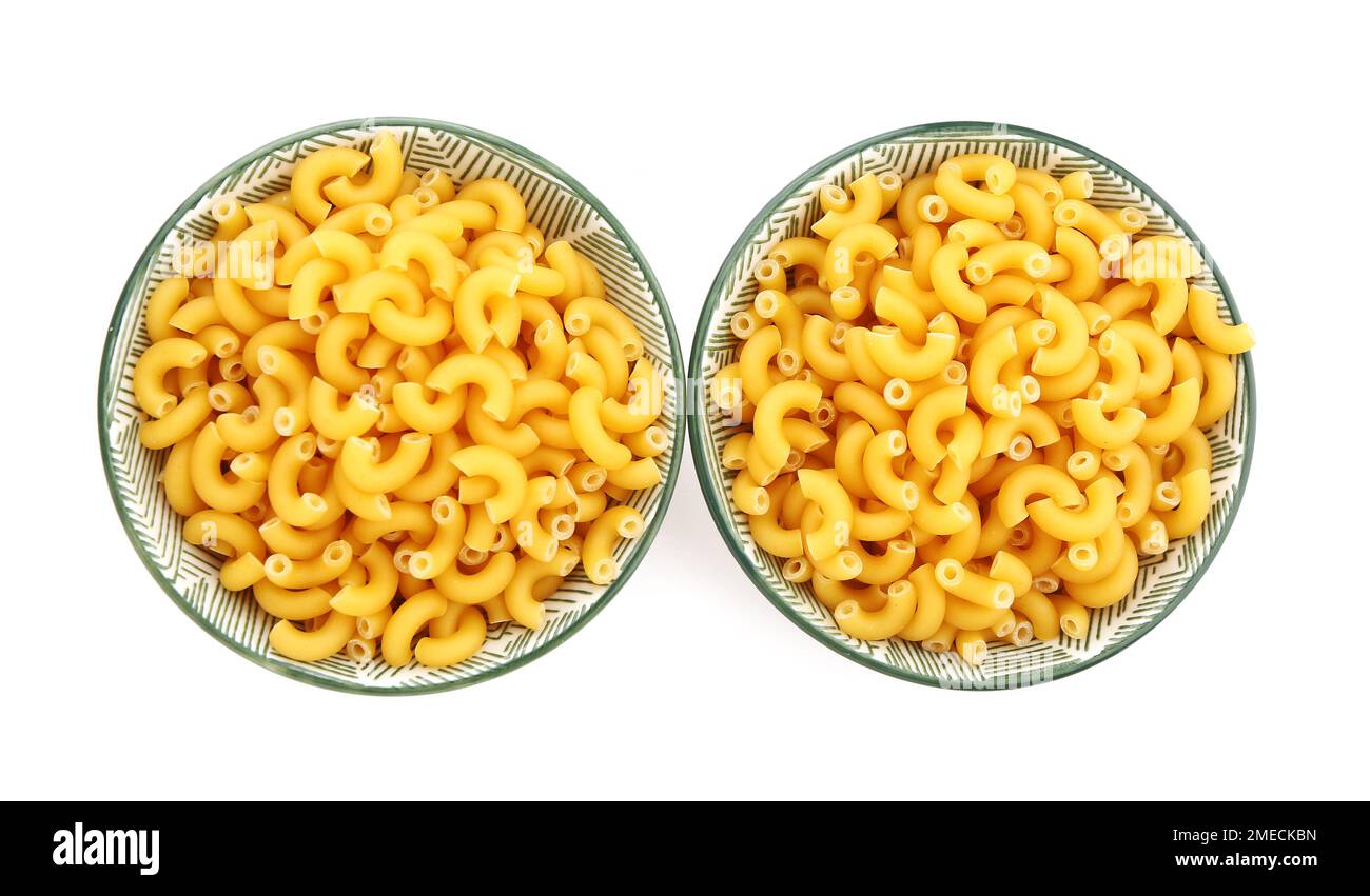 Bowls of raw elbow pasta on white background Stock Photo Alamy