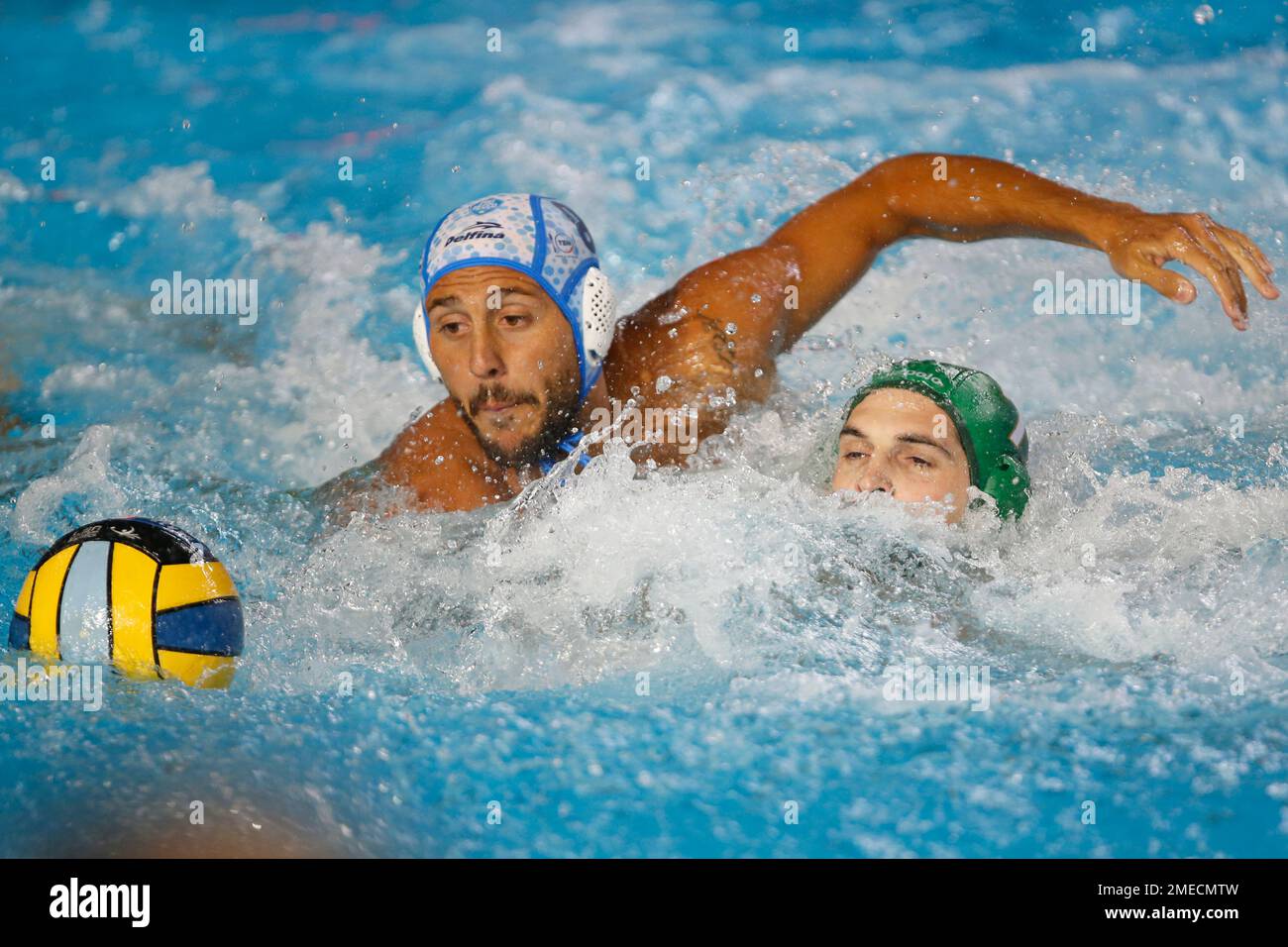 Gonzalo Echenique of Pro Recco, left, and Ioannis Fountoulis of Ferencvaros  swim for a loose ball during their LEN Champions League finals water polo  match in Belgrade, Serbia, Saturday, June 5, 2021. (