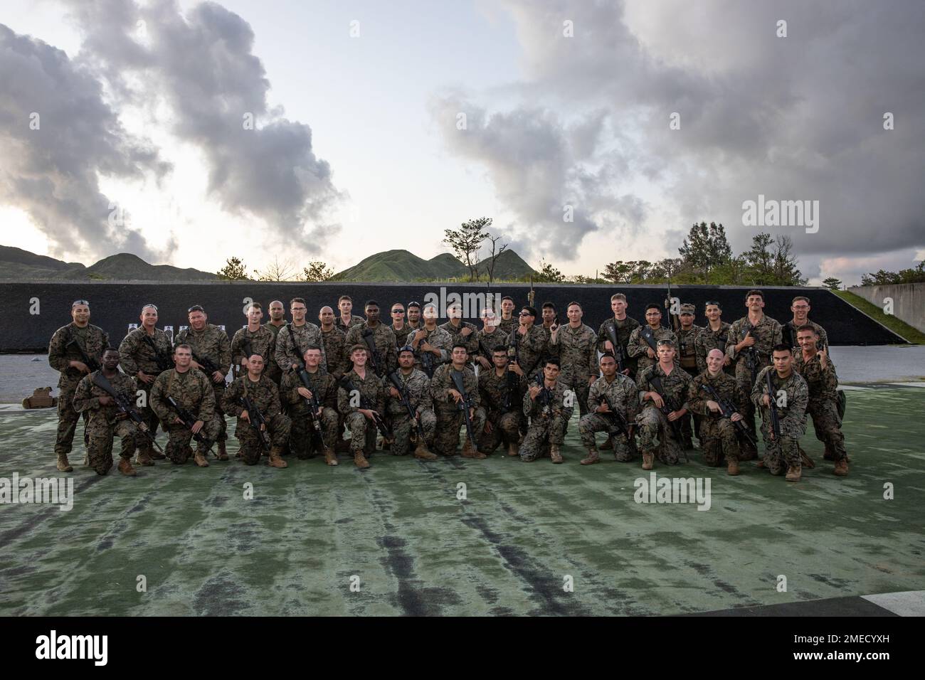 U.S. Marines with 3rd Maintenance Battalion, 3rd Sustainment Group (Experimental), 3rd Marine Logistics Group, pose for a photo during a table three through six and combat marksmanship program range at Camp Hansen, Okinawa, Japan, Aug. 16, 2022. The purpose of the range was to improve the battalion's organic combat marksmanship capabilities and to train the core position safety officers for subsequent company ranges. 3rd MLG based out of Okinawa, Japan, is a forward-deployed combat unit that serves as III Marine Expeditionary Force’s comprehensive logistics and combat service support backbone Stock Photo