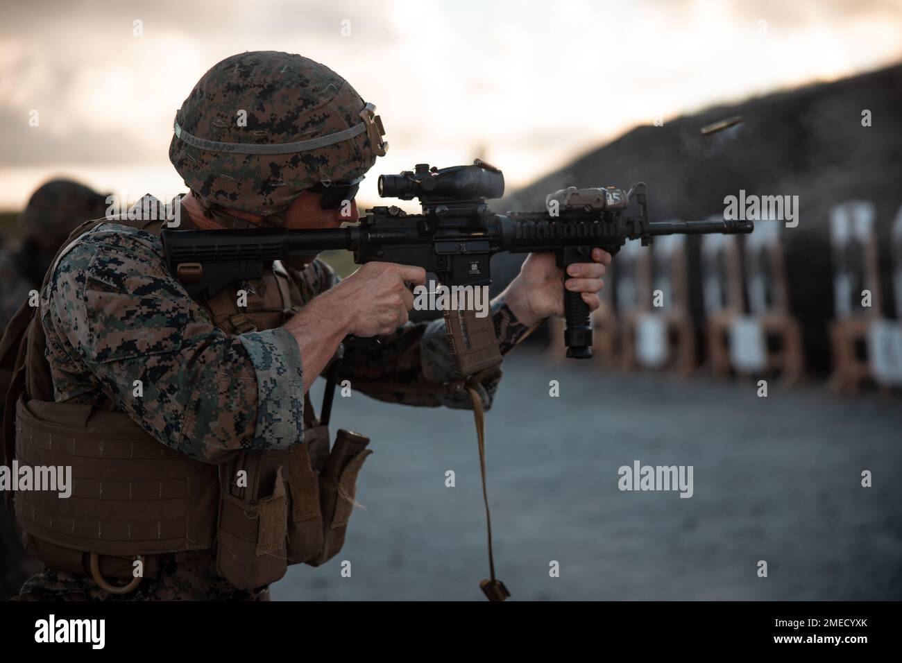 U.S. Marine Corps Sgt. Skyler Kotas, an engineer equipment mechanic with 3rd Maintenance Battalion, 3rd Sustainment Group (Experimental), 3rd Marine Logistics Group, fires an M4 carbine during a table three through six and combat marksmanship program range at Camp Hansen, Okinawa, Japan, Aug. 16, 2022. The purpose of the range was to improve the battalion's organic combat marksmanship capabilities and to train the core position safety officers for subsequent company ranges. 3rd MLG based out of Okinawa, Japan, is a forward-deployed combat unit that serves as III Marine Expeditionary Force’s co Stock Photo